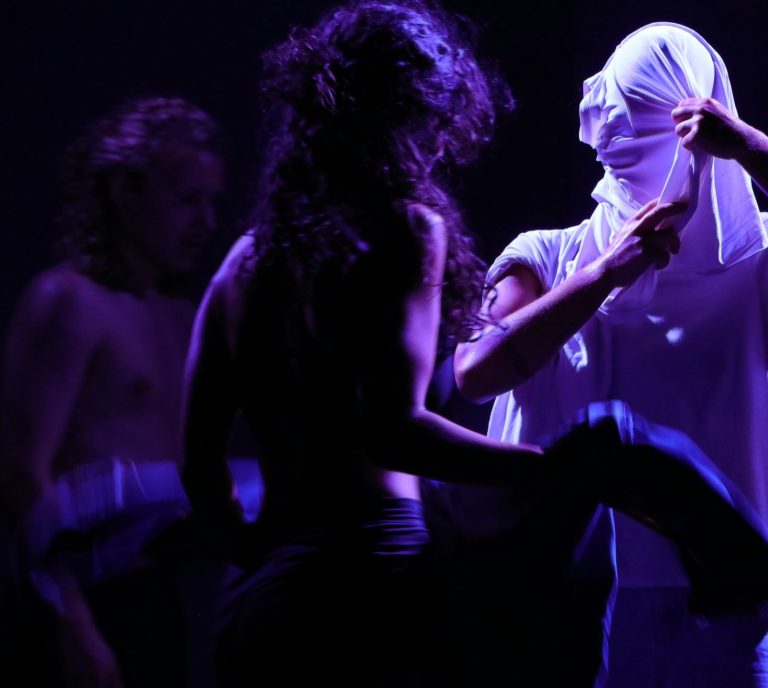 Cours de théâtre : deux comédiennes en mouvement sous une lumière violette